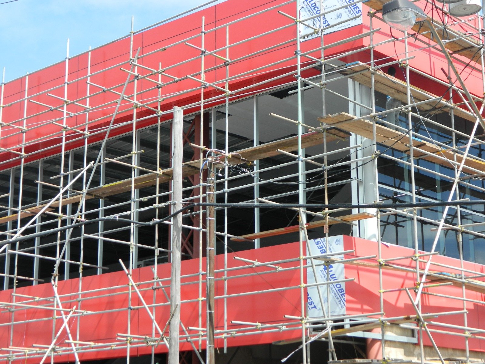 Aluminium composite panels being fixed to a building facade
